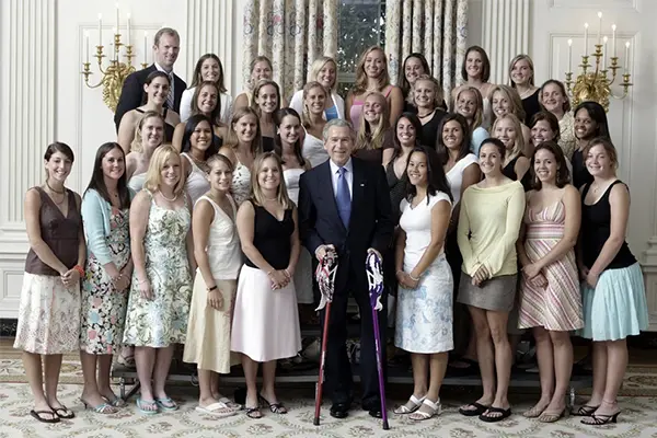 a group of female athletes with a coach